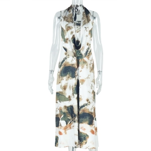 Macro detail of backless deep V-neck halter dress featuring earthy multi-color tie-dye print