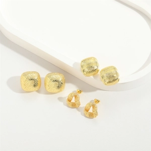 Golden heart earrings and geometric square studs with matte textured metal surface