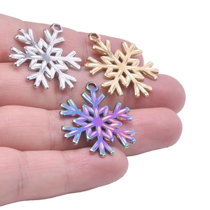 Polished stainless steel snowflake charms in gold silver and rainbow finishes