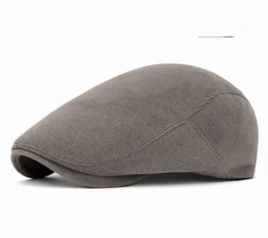 Close-up of gray corduroy beret cap showing fine ribbed texture and detailed stitching