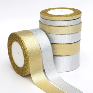 Macro shot of metallic gold and silver glitter ribbons rolls for Christmas DIY decoration