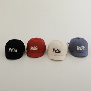 Detail view of cotton baseball caps in four colors with 3D letter embroidery for kids