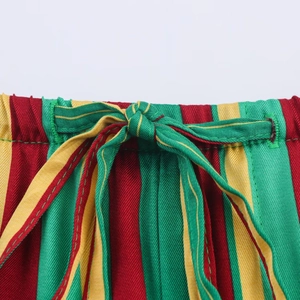 Detail of elastic waist with drawstring on red, green and yellow striped trousers