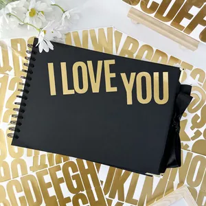 Black spiral scrapbook with gold I LOVE YOU letter stickers and a black satin ribbon bow