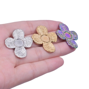 Detail of four-leaf clover stainless steel earring bases in silver, gold and rainbow