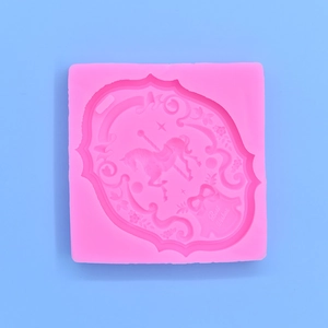 Pink silicone carousel mold with decorative floral patterns and Best Wishes text