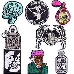 Detailed close-up of eight punk skull embroidery patches with diverse gothic phrases