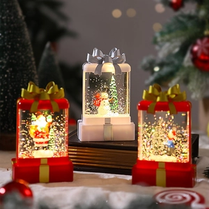 Detailed view of gift box snow globe lanterns with Santa and snowman scenes