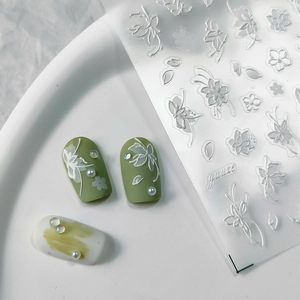 5D embossed white floral nail stickers with thin gauze designs on green and white nails
