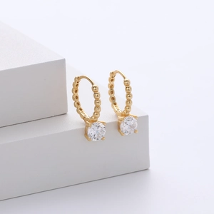 Macro detail of S925 sterling silver gold earrings featuring beaded hoop and round zircon