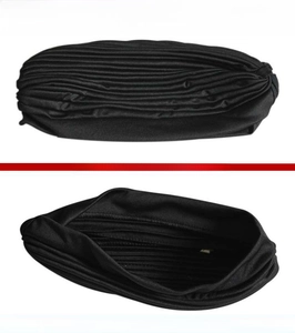 Detail of black pleated turban hat showing high-quality inner lining and outer stitching