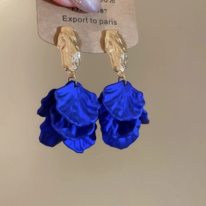 Macro detail of royal blue layered petal earrings with hammered gold texture studs