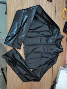 Detailed view of black PU leather cropped jacket featuring metal zipper and stand collar