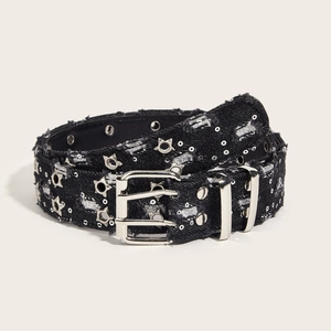 Punk style black denim belt with silver star rivets and double grommets on beige background