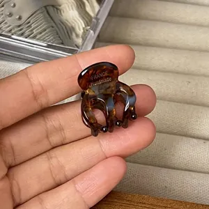 Handmade mini amber tortoiseshell hair claw clip with smooth acetate finish
