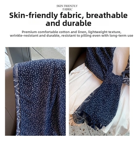 Detail of skin-friendly cotton linen scarf with navy polka dots and fringed edges