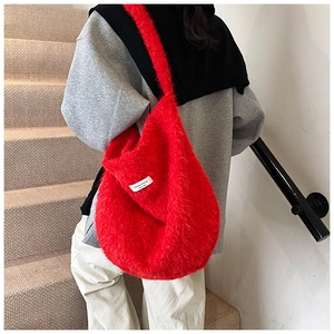 Detailed back view of a plush red hobo bag showing its soft texture and large capacity
