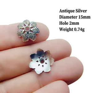 Detail of 15mm antique silver petal bead cap with engraved texture and size markings