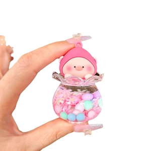 Pink cartoon pig liquid quicksand charm pendant keychain accessory held in hand