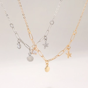 Collane con ciondoli a stella marina e conchiglia in oro e argento con zirconi