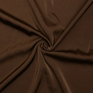 Detail of dark brown satin fabric showing elegant texture and soft drape of the dress