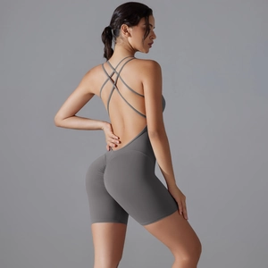 Close-up of the back detail on a grey yoga romper with cross-straps and scrunch butt design