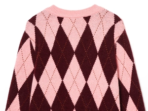 Detailed close-up of argyle knit pattern and ribbed neckline on pink cardigan sweater