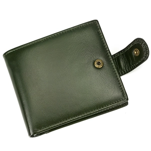 Detailed close-up of dark green oil wax leather wallet texture with metal snap button
