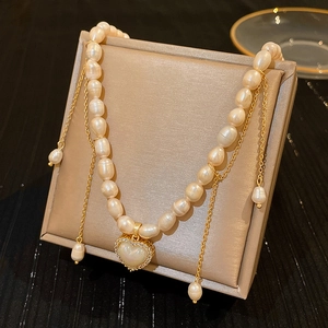 Detail of baroque freshwater pearl necklace with sparkling heart pendant on a luxury box