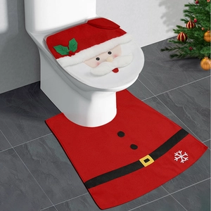 Detail view of red Santa Claus toilet seat cover and matching floor mat in a bathroom