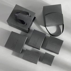 Minimalist dark gray jewelry packaging set with cardboard boxes and matching gift bags