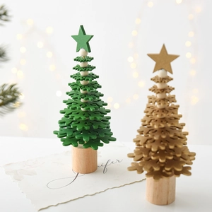 Mini wooden Christmas trees in green and gold with snowflake layers for table decor