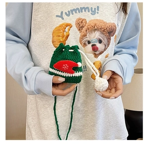 Detail of green crochet reindeer drawstring bag with handmade Christmas hat decorations