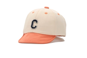 Detailed shot of beige and orange cotton baby baseball cap with embroidered letter C