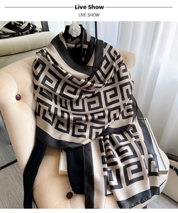 Detail showing elegant greek key pattern on premium silk scarf with smooth texture