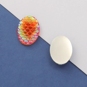 Detailed macro view of 13x18mm oval resin cabochon with orange AB fish scale pattern and back