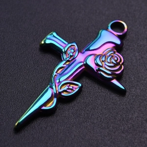 Macro view of rainbow-plated stainless steel cross pendant with rose flower detail