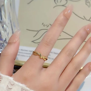Minimalist gold knot ring in stainless steel for women featuring an infinity bond design
