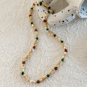 Elegant beaded shell necklace with freshwater pearl and colorful beads on white background
