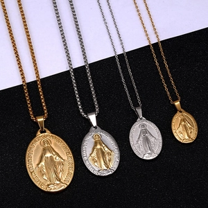 Detailed view of 18K gold and silver stainless steel Virgin Mary oval pendant necklaces