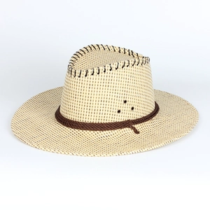 Close-up of beige woven straw cowboy hat with dark stitching and metal ventilation eyelets