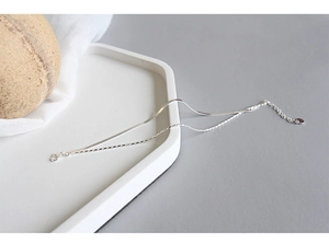 Detail view of a double-layered S925 sterling silver bracelet with snake and block chains