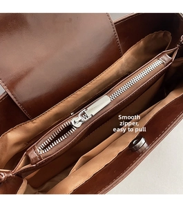 Detail view of large tote bag interior with smooth zipper pocket and magnetic closure