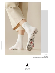 Detail view of cotton reflexology five-finger socks showing foot massage pressure points