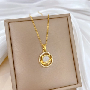 Close-up of golden cat planet pendant with opal stone and zircon pavé on silk