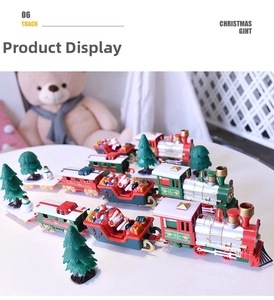 Detailed view of festive electric train set with Santa figures and mini Christmas trees