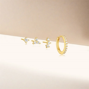 Macro view of gold S925 silver earring set with zircons in various geometric shapes