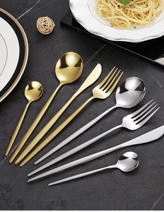 Eight-piece gold and silver stainless steel cutlery set on premium black marble background