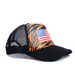 Detail view of American flag on orange tiger print trucker hat with breathable mesh back