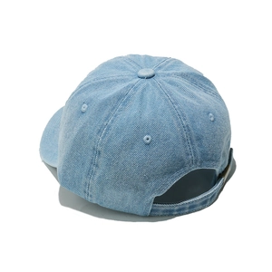 Detail view of light blue denim baseball cap back with adjustable metal strap buckle